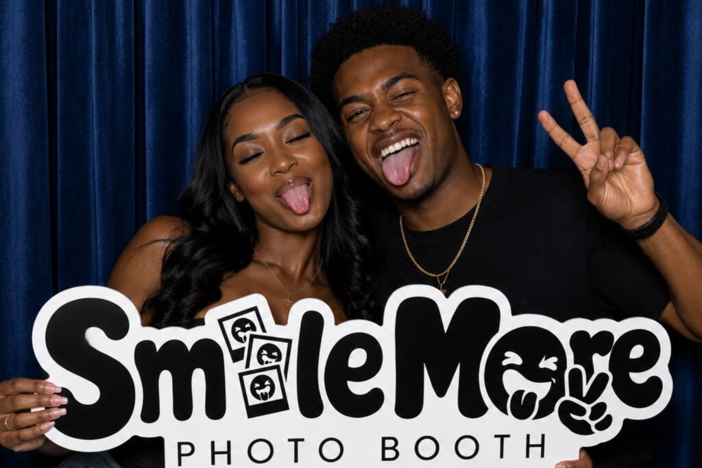 Couple posing with peace signs in a SmileMore photo booth