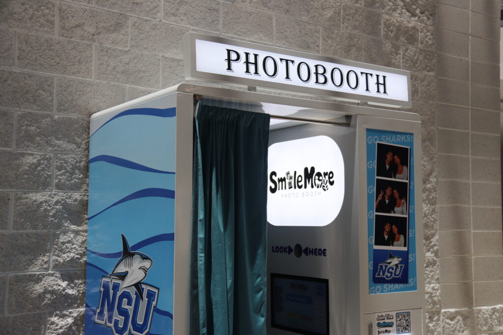 Finished SmileMore photo booth install in the NSU lobby, wrapped in Sharks blue