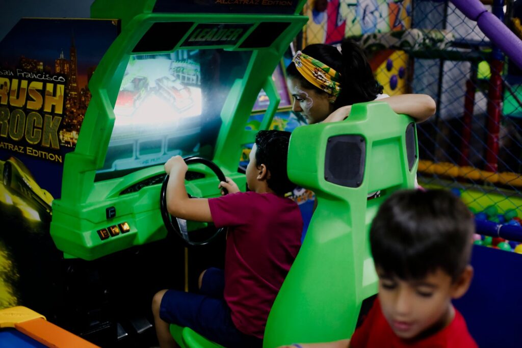Child playing a racing game at an arcade