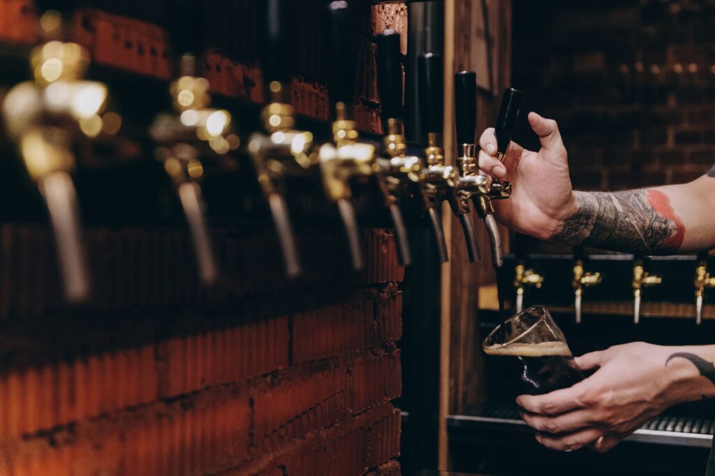 Craft beer poured from a tap in a taproom