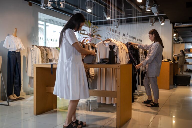 Two women browsing clothes in a boutique