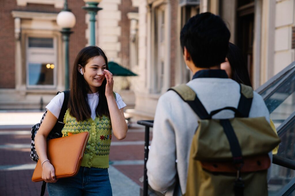 Students socializing outdoors on a university campus