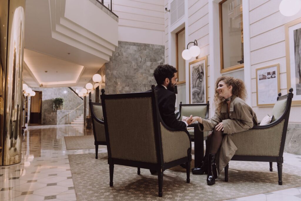 Couple sitting together in an elegant hotel lobby