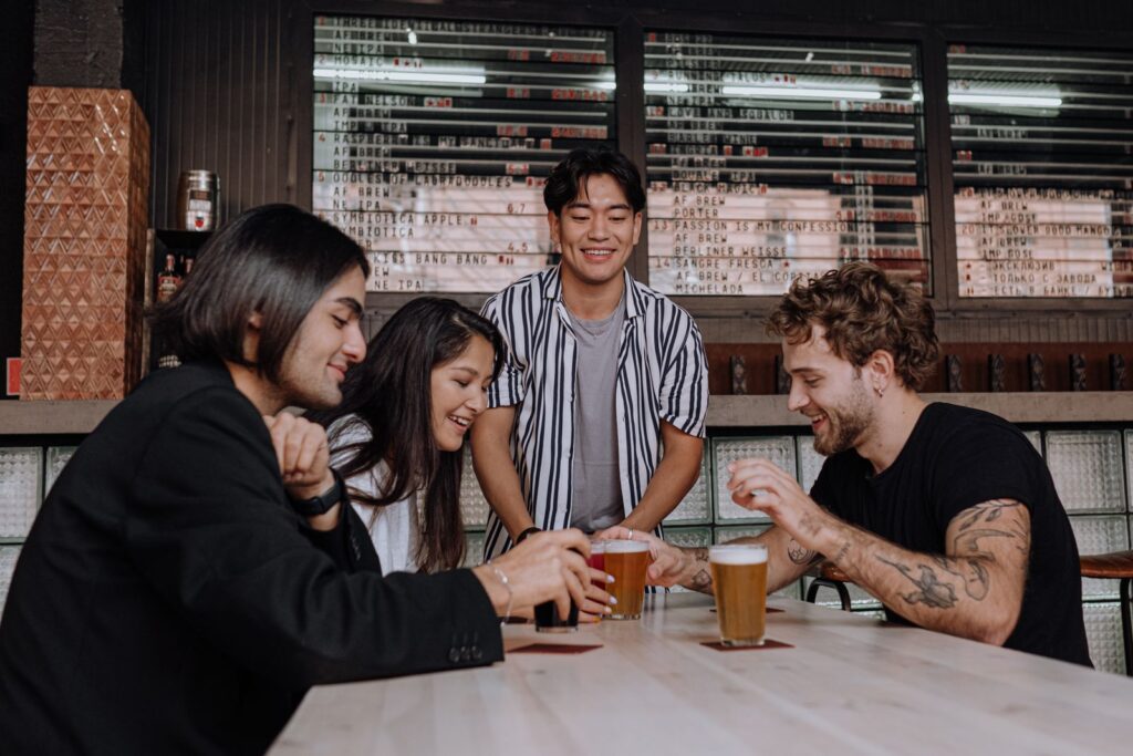 Group of young adults sharing drinks at a lively venue