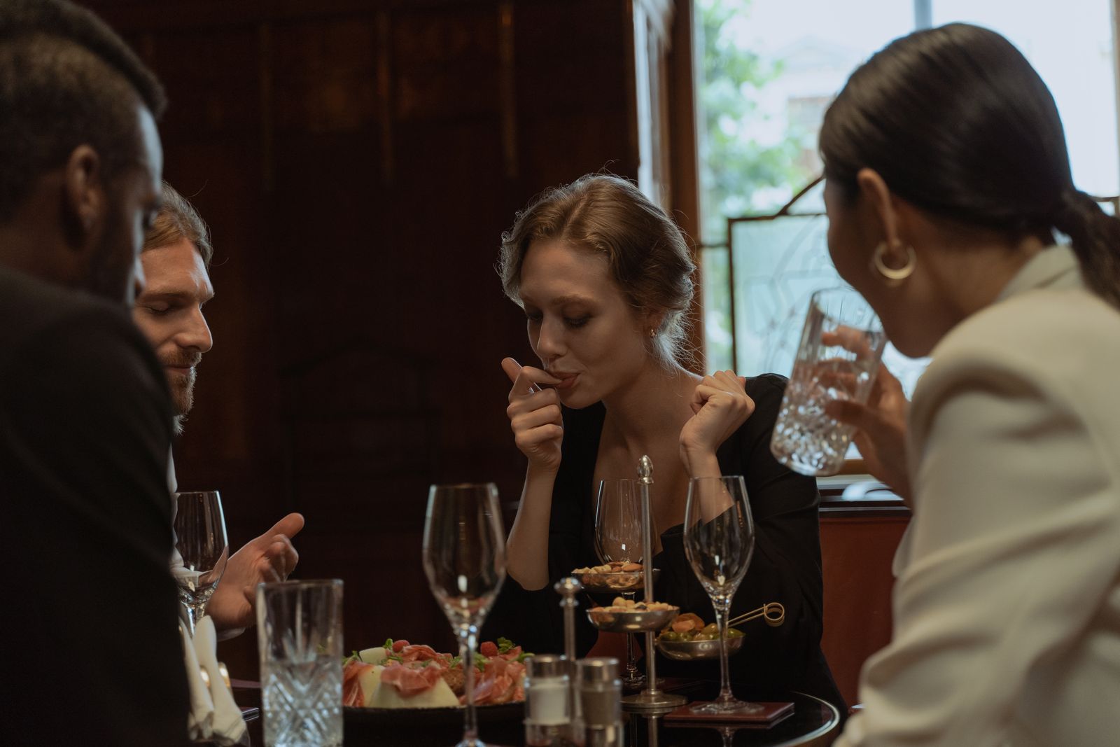 Friends sharing dinner and drinks at a stylish restaurant built to make your restaurant instagrammable