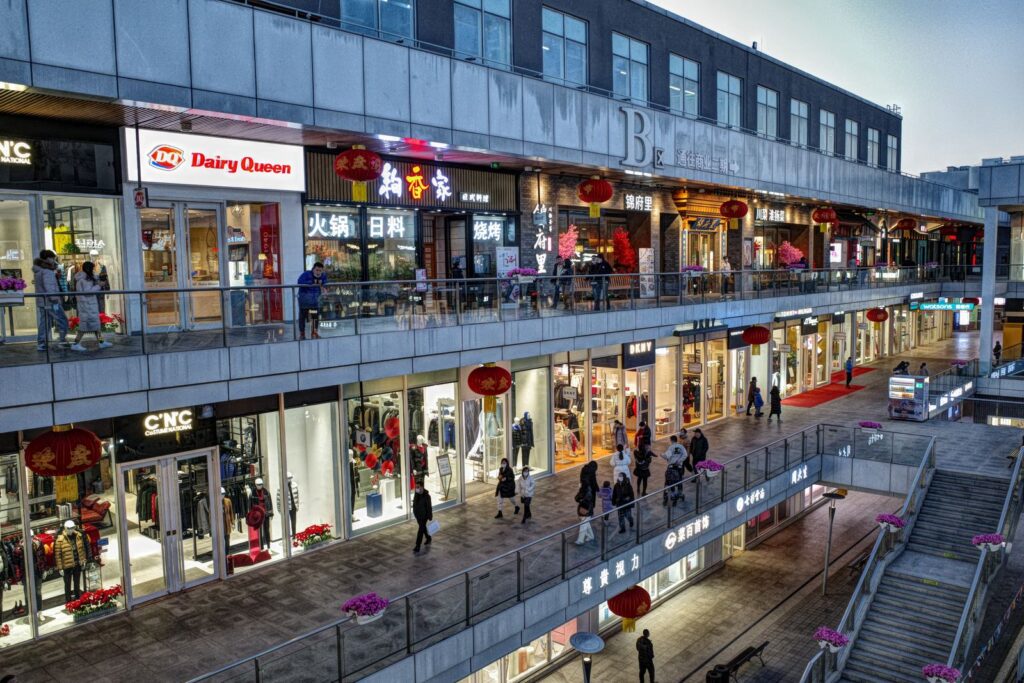 Evening crowd walking past shops in a modern mall