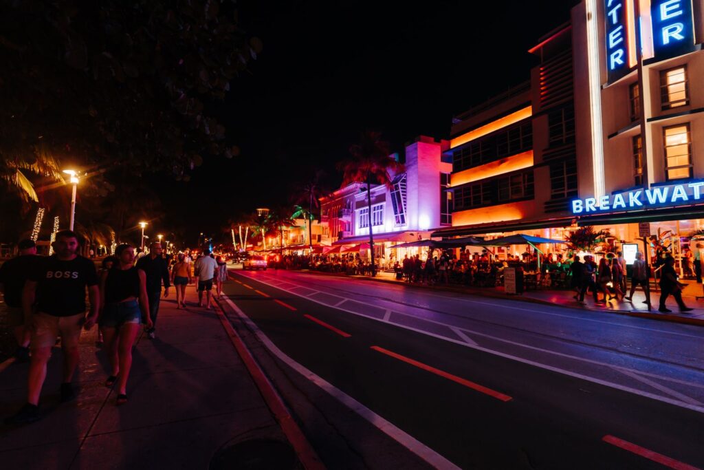 Neon-lit Miami nightlife street crowded with people