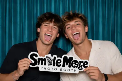 Two friends laughing in the booth