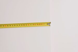 Yellow tape measure against a wall