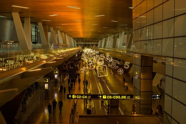Busy airport terminal concourse with travelers